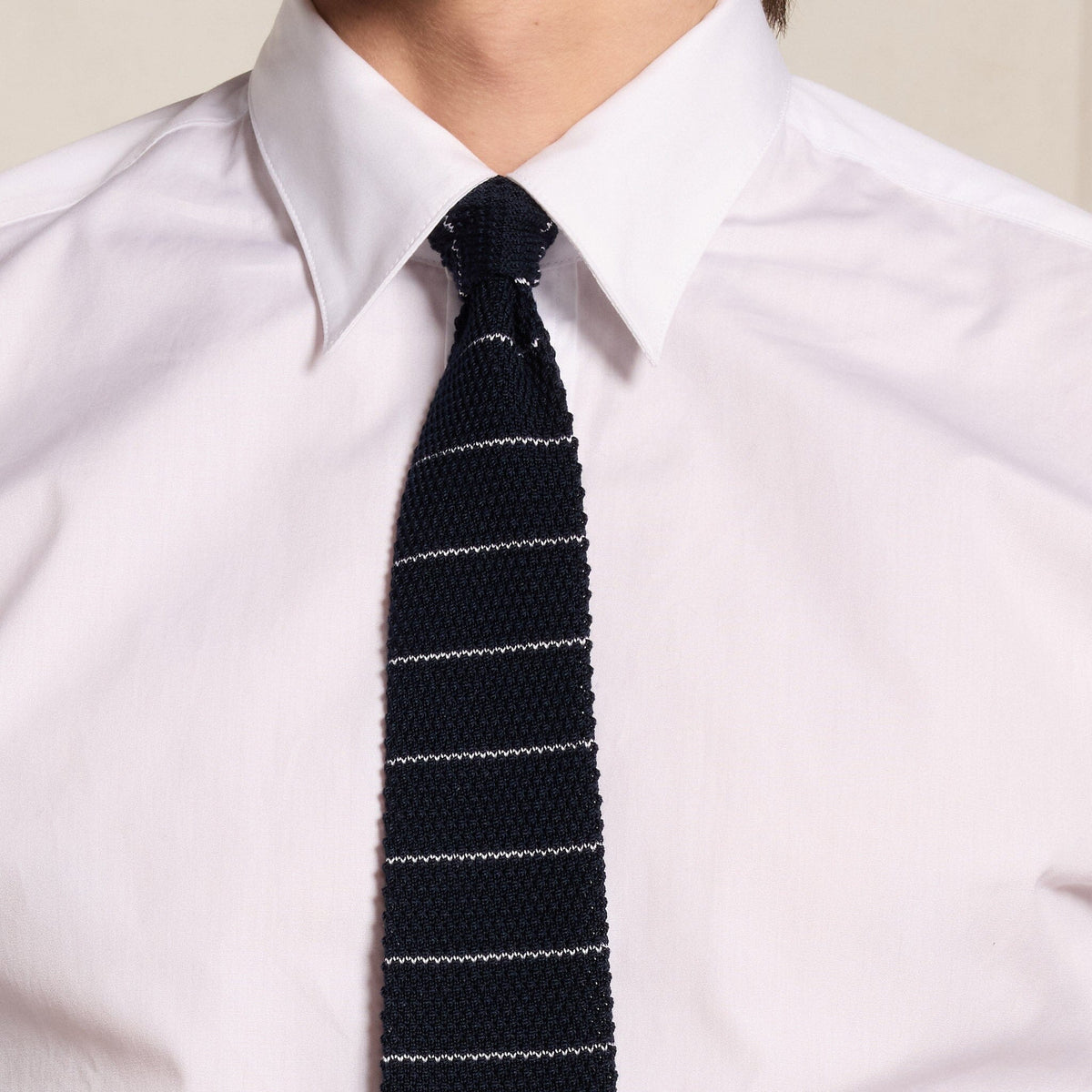 Navy knitted tie with white stripes